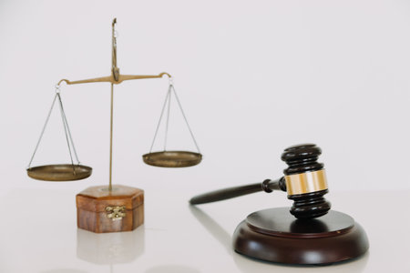 Business and lawyers discussing contract papers with brass scale on desk in office. Law, legal...