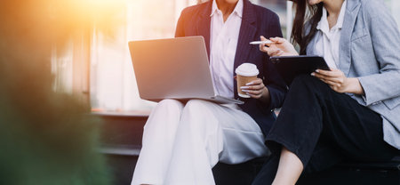 Working together on project. Two young business colleagues working on computerの写真素材