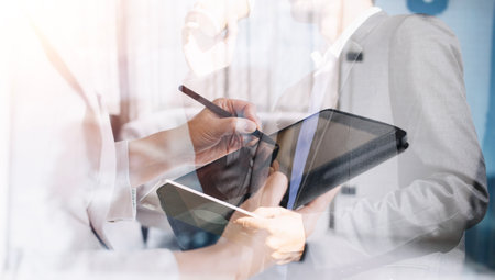 Businessman and team analyzing financial statement Finance task. with smart phone and laptop and tablet. Wealth management conceptの写真素材