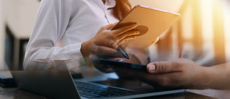 close up hands multitasking man using tablet, laptop and cellphone connecting wifi