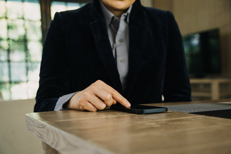 Mature businessman using a digital tablet to discuss information with a younger colleague in a...