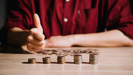 Saving money concept preset by Male hand putting money coin stack growing businessの写真素材