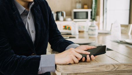 Mature businessman using a digital tablet to discuss information with a younger colleague in a modern business loungeの写真素材