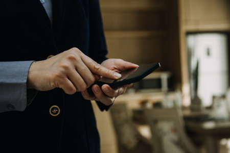 Mature businessman using a digital tablet to discuss information with a younger colleague in a modern business loungeの写真素材