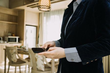 Mature businessman using a digital tablet to discuss information with a younger colleague in a modern business loungeの写真素材