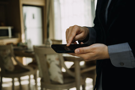 Mature businessman using a digital tablet to discuss information with a younger colleague in a modern business loungeの写真素材
