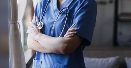 Homecare nursing service and elderly people cardiology healthcare. Close up of young hispanic female doctor nurse check mature caucasian man patient heartbeat using stethoscope during visitの写真素材