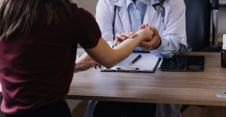 Homecare nursing service and elderly people cardiology healthcare. Close up of young hispanic female doctor nurse check mature caucasian man patient heartbeat using stethoscope during visitの写真素材