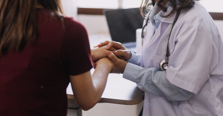 Homecare nursing service and elderly people cardiology healthcare. Close up of young hispanic female doctor nurse check mature caucasian man patient heartbeat using stethoscope during visitの写真素材