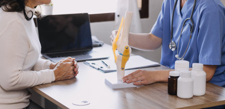 Homecare nursing service and elderly people cardiology healthcare. Close up of young hispanic female doctor nurse check mature caucasian man patient heartbeat using stethoscope during visitの写真素材