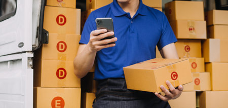 Entrepreneurs Small Business SME Independent men work at home Use smartphones and laptops for commercial checking, online marketing, packing boxes, SME sellers, concept, e-commerce team, online salesの写真素材