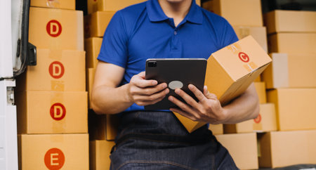 Entrepreneurs Small Business SME Independent men work at home Use smartphones and laptops for commercial checking, online marketing, packing boxes, SME sellers, concept, e-commerce team, online salesの写真素材