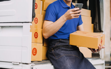 Entrepreneurs Small Business SME Independent men work at home Use smartphones and laptops for commercial checking, online marketing, packing boxes, SME sellers, concept, e-commerce team, online salesの写真素材