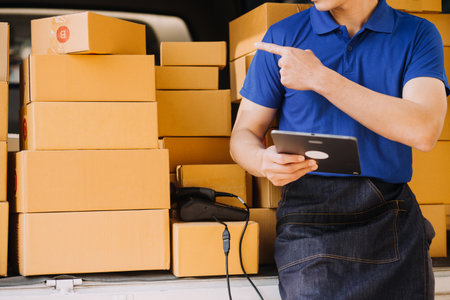 Entrepreneurs Small Business SME Independent men work at home Use smartphones and laptops for commercial checking, online marketing, packing boxes, SME sellers, concept, e-commerce team, online salesの写真素材