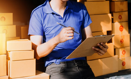 Small business aspiring entrepreneur, small and medium business freelance working in home office using computer, online marketing packaging box delivery, SME e-commerce telemarketing concept.の写真素材