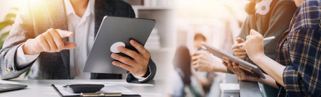Financial analysts analyze business financial reports on a digital tablet planning investment...