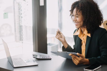 Financial analysts analyze business financial reports on a digital tablet planning investment...