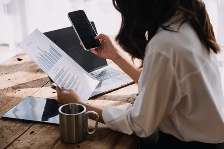Entrepreneur Asian businessman and businesswoman discussing new business project in tablet in modern Meeting In Modern Office, Asian business casual concept.の写真素材