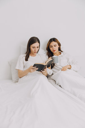 Were friends, lovers and soulmates. Shot of a young couple using a laptop while lying on their bed.の写真素材