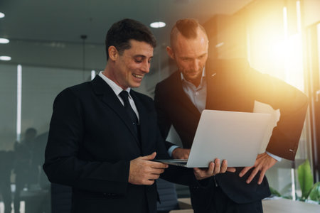Financial analysts analyze business financial reports on a digital tablet planning investment project during a discussion at a meeting of corporate showing the results of their successful teamwork.の写真素材