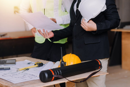 Two business man construction site engineer. Engineering objects on workplace with partners...