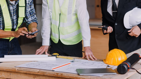Two business man construction site engineer. Engineering objects on workplace with partners...