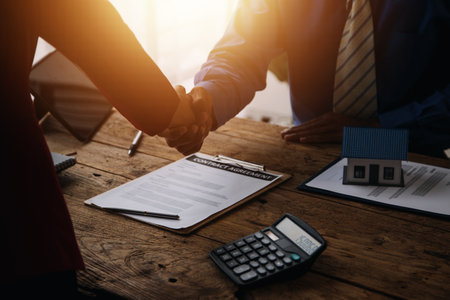 Real estate brokerage agent Deliver a sample of a model house to the customer, mortgage loan agreement Making lease and buy and sell house And contract home insurance mortgage loan conceptの写真素材