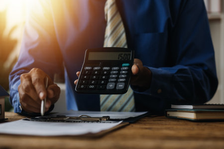 Financial analysts analyze business financial reports on a digital tablet planning investment project during a discussion at a meeting of corporate showing the results of their successful teamwork.の写真素材