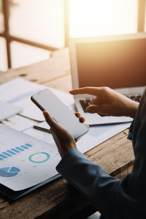 Businesswoman or accountant working Financial investment on calculator, calculate, analyze business and marketing growth on financial document data graph, Accounting, Economic, commercial concept.の写真素材