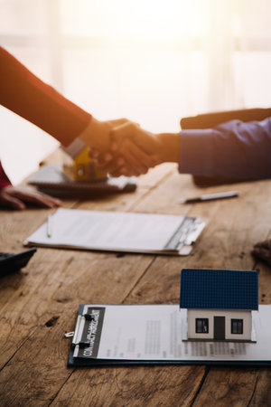 Real estate brokerage agent Deliver a sample of a model house to the customer, mortgage loan agreement Making lease and buy and sell house And contract home insurance mortgage loan conceptの写真素材