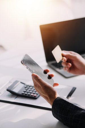 Close up of woman hand using credit card and laptop for payment and online shopping, Online shopping, payments digital banking, E-commerce concept.の写真素材