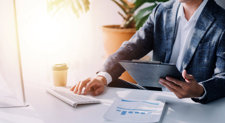 Financial analysts analyze business financial reports on a digital tablet planning investment...