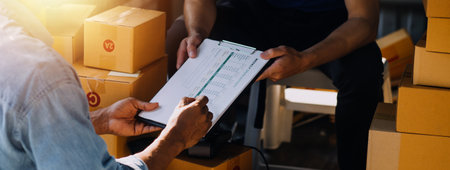 Startup small business entrepreneur of freelance Asian woman using a laptop with box Cheerful...