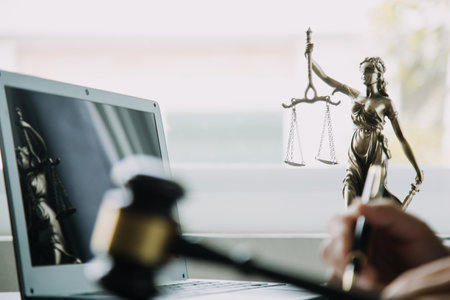Justice and Law concept. Legal counsel presents to the client a signed contract with gavel and legal law or legal having team meeting at law firm in backgroundの写真素材