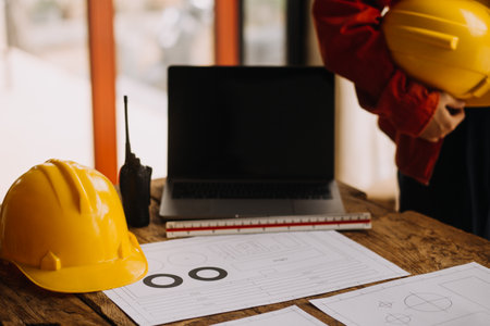 Construction and structure concept of engineer working drawing on blueprint meeting for project working with partner on model building and engineering tools in working site, construction conceptの写真素材