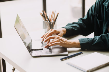 Teamwork of asian business people discussing and calculating with calculator on evaluation data in conference room. with the growth and pointing to the chart graph financial account.の写真素材