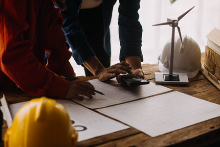 Construction and structure concept of engineer working drawing on blueprint meeting for project...
