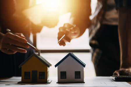 Construction and structure concept of engineer working drawing on blueprint meeting for project working with partner on model building and engineering tools in working site, construction conceptの写真素材