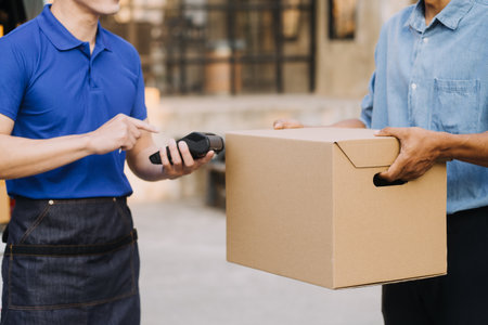 Asian business men use laptop computer checking customer order online shipping boxes at home. Starting Small business entrepreneur SME freelanceの写真素材