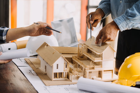 Two business man construction site engineer. Engineering objects on workplace with partners interacting on backgroundの写真素材