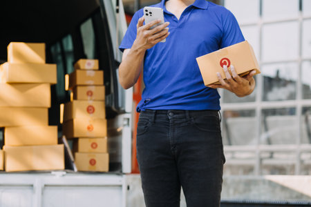 SME entrepreneur Small business entrepreneurs Online selling ideas,Happy Young Asian business owner work on computer and a boxs at home,delivery SME procurement package box deliver to customers,の写真素材