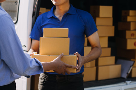 SME entrepreneur Small business entrepreneurs Online selling ideas,Happy Young Asian business owner work on computer and a boxs at home,delivery SME procurement package box deliver to customers,の写真素材