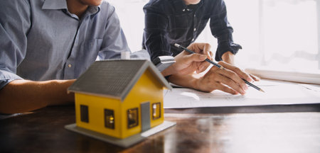 Construction and structure concept of Engineer or architect meeting for project working with partner and engineering tools on model building and blueprint in working site, contract for both companies.の写真素材