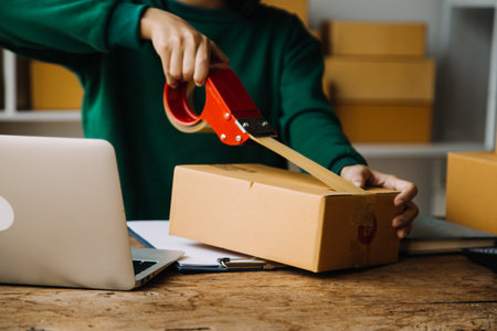 Startup small business entrepreneur or freelance Asian woman using a laptop with box, Young success...