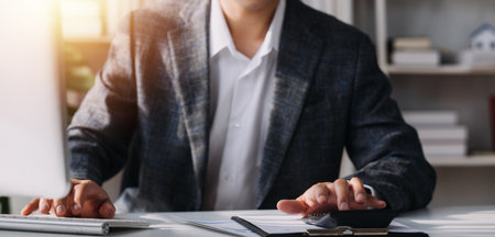 Financial analysts analyze business financial reports on a digital tablet planning investment project during a discussion at a meeting of corporate showing the results of their successful teamwork.の写真素材
