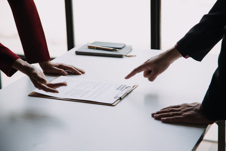 Close up view of job interview in office, focus on resume writing tips, employer reviewing good cv of prepared skilled applicant, recruiter considering application, hr manager making hiring decisionの写真素材