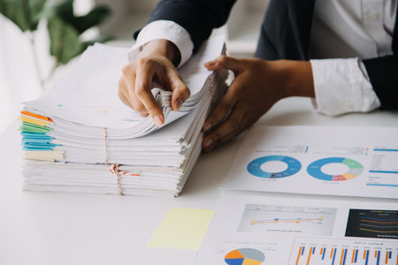 Financial analysts analyze business financial reports on a digital tablet planning investment...
