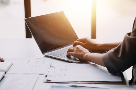 Financial analysts analyze business financial reports on a digital tablet planning investment...