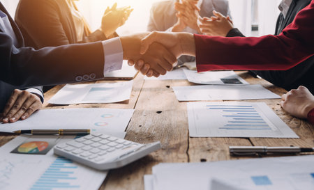Business handshake for teamwork of business merger and acquisition,successful negotiate,hand shake,two businessman shake hand with partner to celebration partnership and business deal conceptの写真素材