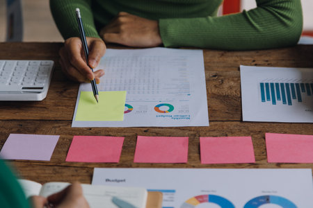 Financial analysts analyze business financial reports on a digital tablet planning investment...